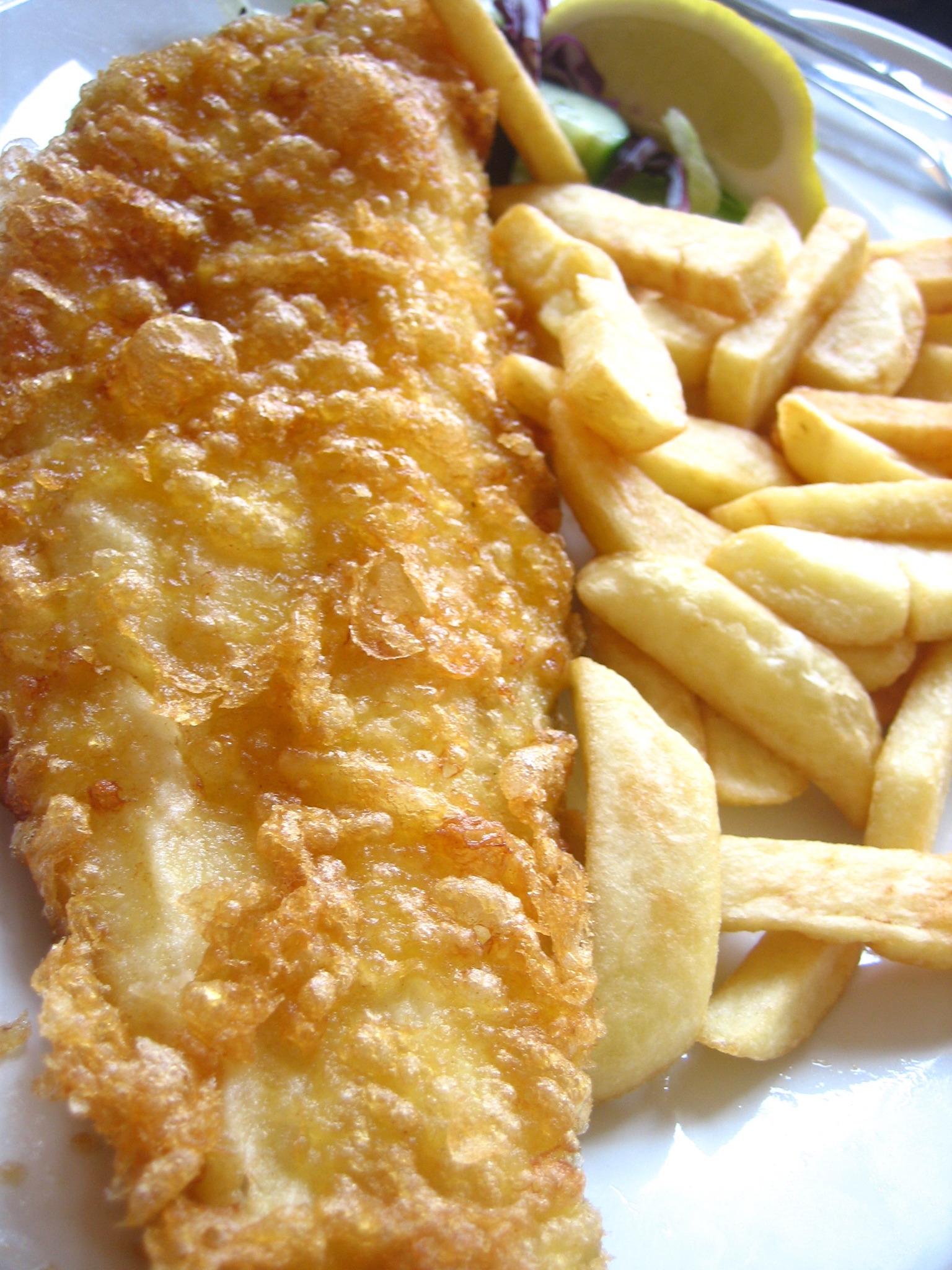 Close view of crisp batter beside chunky chips (stand-in photograph, Brighton)